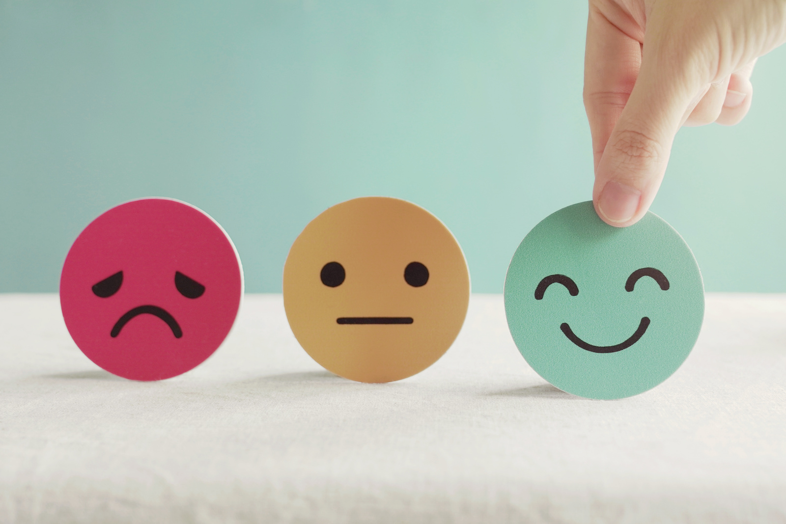 Hand choosing green happy smiley face paper cut, product, user, service feedback rating and customer reveiw, experience, satisfaction survey, psychology mental health test concept